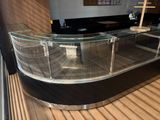 a glass counter with a cross on top of it