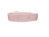 the pink dog collar has gold hearts on it