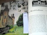 an open book with a picture of a castle on it