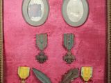 a picture of a framed picture of medals and other items