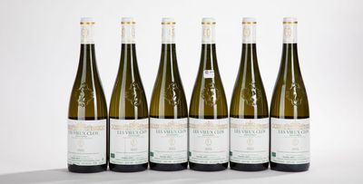 six bottles of white wine lined up in a row