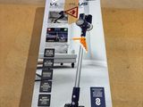 the box of a vacuum cleaner is open on the floor