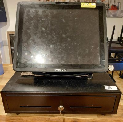 an image of a laptop computer sitting on top of a cash register