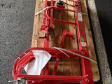 a red hand truck with a wooden pallet on it