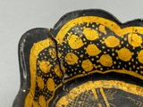 a black and yellow bowl with a picture of a man on it