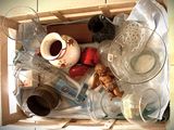 a box full of empty glassware and other items