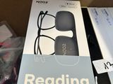 a box with a book and a pair of glasses in it