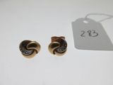 une paire de boucles d'oreilles dorées ornées d'un motif en spirale