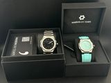 two watches in a box on a black table