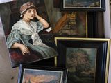 a box full of paintings and pictures on a table