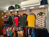 many shirts hanging on the wall in the store