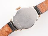 a close up of a watch on a white surface