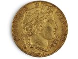 a close up of a gold coin on a white surface