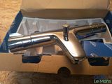 a silver faucet in a box on a table