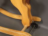 wooden rocking horse on wheels on a grey background