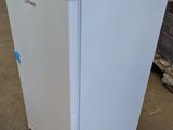 an image of a white refrigerator in a warehouse