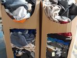 two boxes with clothes on top of them in a warehouse