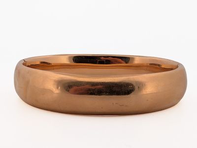 a close up of a gold ring on a white background