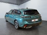 the rear end of a blue car parked in a garage