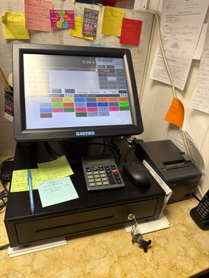 a desktop computer sitting on a desk with a calculator and telephone