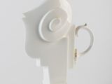 a white vase with a white head on it