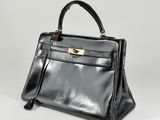 a black leather handbag on a white background