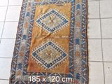 a rug on the floor with a pair of scissors next to it