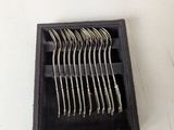 a picture of a set of forks and spoons in a black box