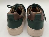 green and brown sneakers with laces on top of them