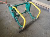 a green and yellow bike rack on the ground