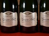three bottles of champagne sitting on a table next to each other