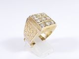a close up of a gold ring with diamonds on a white surface