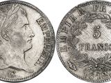 a silver coin with a woman ' s face and laurels on it