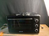 a black toaster oven sitting on top of a wooden table