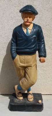 a figurine of a man standing on a base