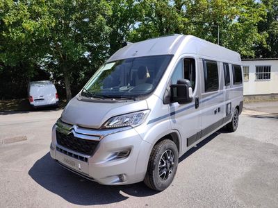 a silver van that is parked in the parking lot