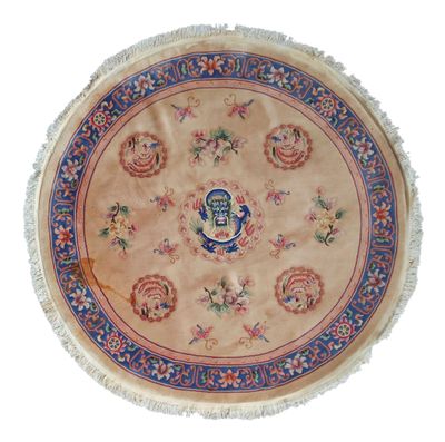 a round rug with a blue and red design on it