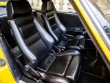 two black seats in the back of a yellow car