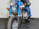 a blue motorcycle that is parked in a garage