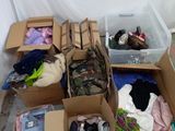 many boxes of clothes and other items in a room