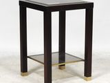 a black and gold side table with a glass shelf