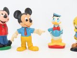three figurines of mickey mouse, donald duck, goofy duck and donald duck