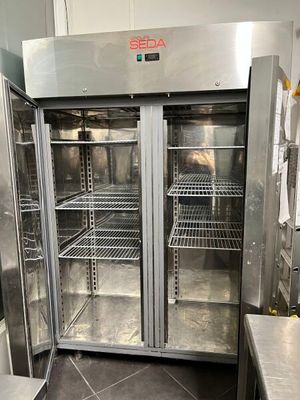 stainless steel double door refrigerator in a commercial kitchen