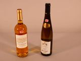 two bottles of wine sitting next to each other on a table