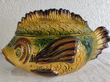 a ceramic fish bowl with a lid on a table