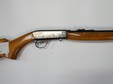 a rifle that is on display on a white surface