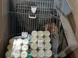 a cage filled with cans and food inside of a box