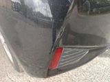 a close up of a car ' s rear end with a reflection of a person in the mirror