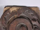 a close up of a carved wooden object on a table