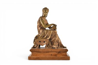 an image of a bronze statue of a woman sitting on a stool